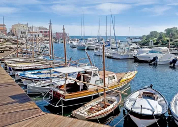 Stintino dock with boats and wooden boardwalk