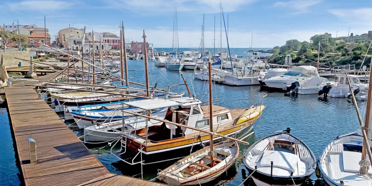 Stintino dock with boats and wooden boardwalk